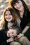 Happy mother with two daughters have fun on the beach at sunset.