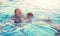 Happy mother with two sons in swimming pool