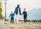 Happy mother with two sons walking by the lake