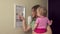 Happy mother woman with little daughter girl turn on lever in fuse box