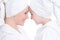 Happy mother and young daughter in white dressing gown