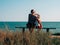 Happy motherand daughter sitting on bench with marine landscape view. Mom and child having fun walking together