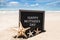 Happy Mothers day beach background with black board and starfishes