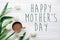 Happy mothers day text sign on tulips and coffee on white wooden