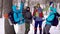 Happy and motivated group of hikers putting their hands together in the middle of a winter forest, team-building.