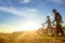 Happy mountainbike couple outdoors have fun together on a summer afternoon sunset