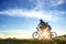 Happy mountainbike couple outdoors have fun together on a summer afternoon sunset