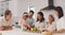 Happy multi generation family cooking together in the kitchen. Asian kids, parents and grandparents chopping vegetables