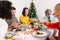 Happy multi generational family enjoying christmas dinner at home