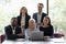 Happy multi national colleagues sit in office pose for camera