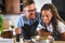 Happy multiethnic couple preparing home made tomato and basil pasta. Cooking at home