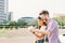 Happy multiethnic couple taking selfie during sunset in the city, fun and smiling, love or gadget technology concept