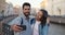 Happy multiethnic couple of tourists taking selfie in old city