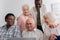 Happy multiethnic pensioners with yarn and