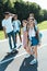 happy multiethnic teenage classmates walking together