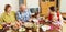 Happy multigeneration family communicate over table