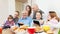 Happy multigeneration family uses electronic devices