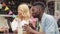 Happy multiracial couple eating wok at food truck