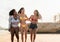 Happy multiracial females with different body size having fun on the beach during summer holiday