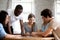 Happy multiracial friends assembling puzzle jigsaw together