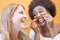 Happy multiracial millennials girls having fun together playing with hairs - Young trendy women laughing and smiling together -