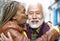 Happy multiracial senior couple having tender moments in city