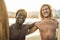 Happy multiracial surfers having fun on the beach after surf session - Soft focus on african man face