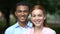 Happy multiracial teenage couple smiling at camera, first date in park, love