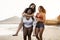 Happy multiracial women with different bodies and skins having fun in summer day on the beach - Main focus on african girl face