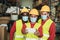 Happy multiracial workers taking a selfie inside warehouse while waring safety masks - Focus on woman face