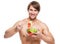Happy muscular man eating a salad.