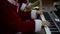 Happy musicians performing Christmas songs on piano and saxophone at concert