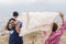 Happy Muslim family portraits outdoor playing with scarf in wind