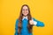 Happy nerdy-looking girl child give thumbs up satisfaction hand gesture yellow background, childhood