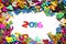 Happy new year 2016 from sparkles colorful glitters numbers on white background and around other numbers