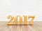 Happy New year 2017 (3d rendering) gold color number on wood plank floor and white brick wall, Holiday greeting card