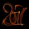 Happy new year 2017 flying digits numbers written with fire flame light on black background