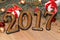 Happy new year 2017 gold figures on the wooden background