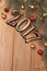 Happy new year 2017 gold figures on the wooden background with Christmas decorations close, balls and gifts