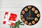 Happy New Year 2020! Clock face showing 12 o`clock, creative food idea with smoked salmon canapes and gift over wooden table