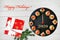 Happy New Year 2020! Clock face showing  12 o`clock, creative food idea with smoked salmon canapes and gift over wooden table