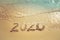 Happy New Year 2020 concept, 2020 number lettering on the sea beach.