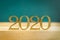 Happy New Year 2020. Creative text Happy New Year 2020 written in gold wooden letters