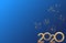 Happy New Year 2020 golden numbers design isolated on blue background with fireworks. Holiday banner, poster, flyer, greeting card