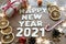 Happy new year 2021. Christmas composition. New year`s layout on a dark wooden background. Cones, toys, gift, garland