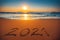 Happy New Year 2021 concept, lettering on the beach. Sea sunrise