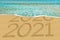 Happy New Year 2021 and leaving year of 2020 concept text on the sea beach