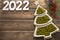 Happy New Year 2022. New Year\\\'s green peas in saucers in the form of a Christmas tree. with white numbers 2022