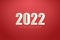 Happy new year 2022 with pure white numbers on a red background.