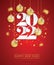 Happy new year 2022. White paper numbers with golden Christmas decoration and confetti on red background.